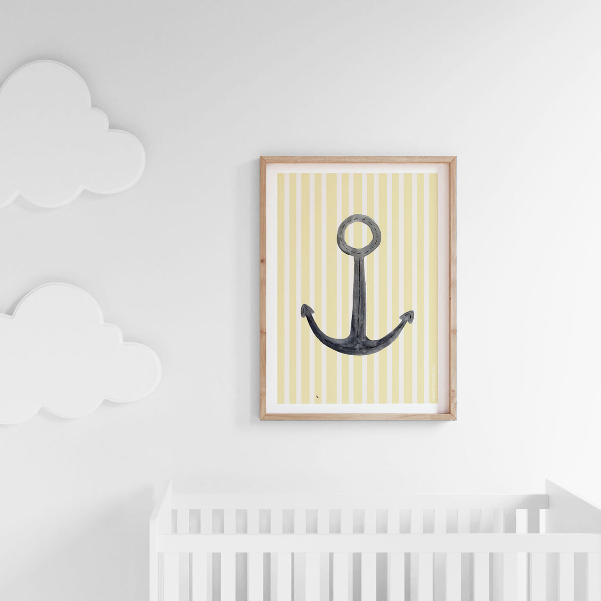 Nautical and minimal anchor print with yellow and white stripes, hung in baby nursery. Modern nursery with pop of colour from this print.