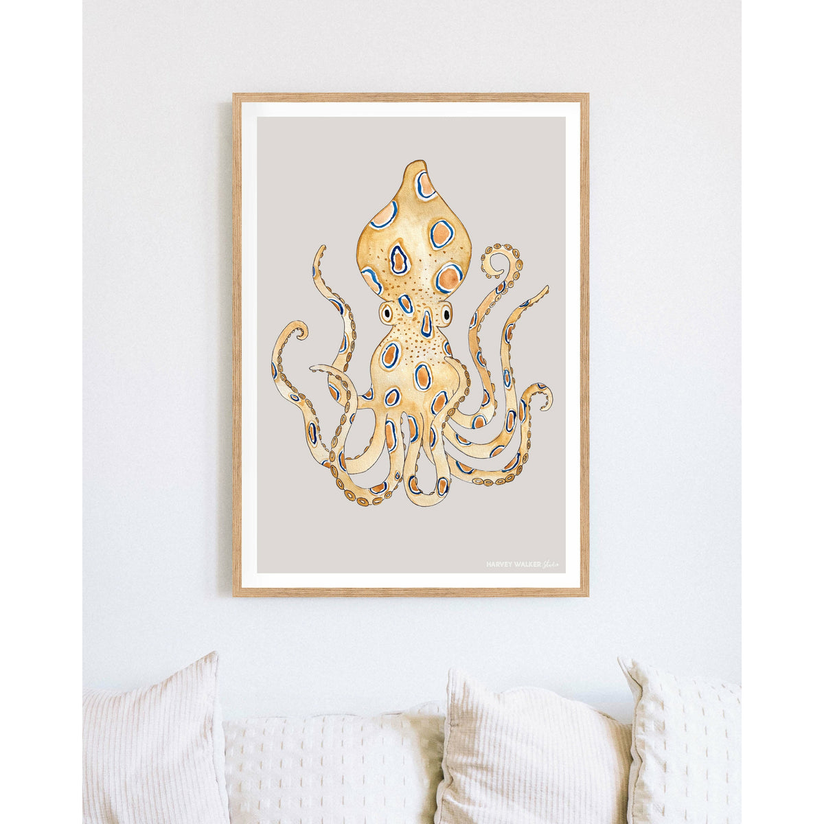 Different coastal art. This warm coloured print with grey background and blue ring octopus as the main feature will bring a coastal vibe to your living room.